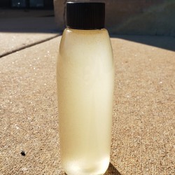 Bottle of cloudy liquid containing baby brine shrimp
